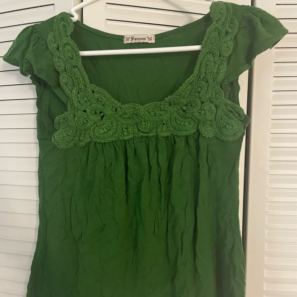 Green top with crochet lace detail